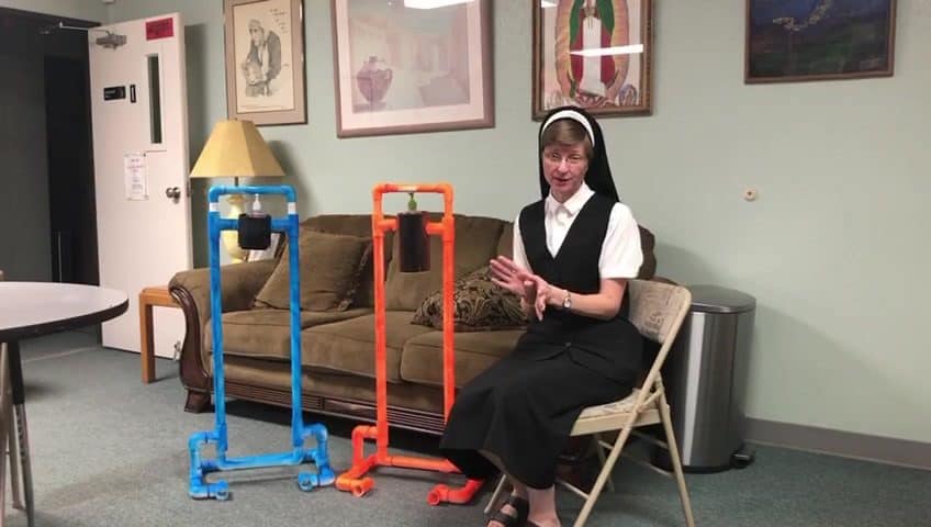 Franciscan Sister Demonstrates St. Peter Mission Sanitizer Dispensar